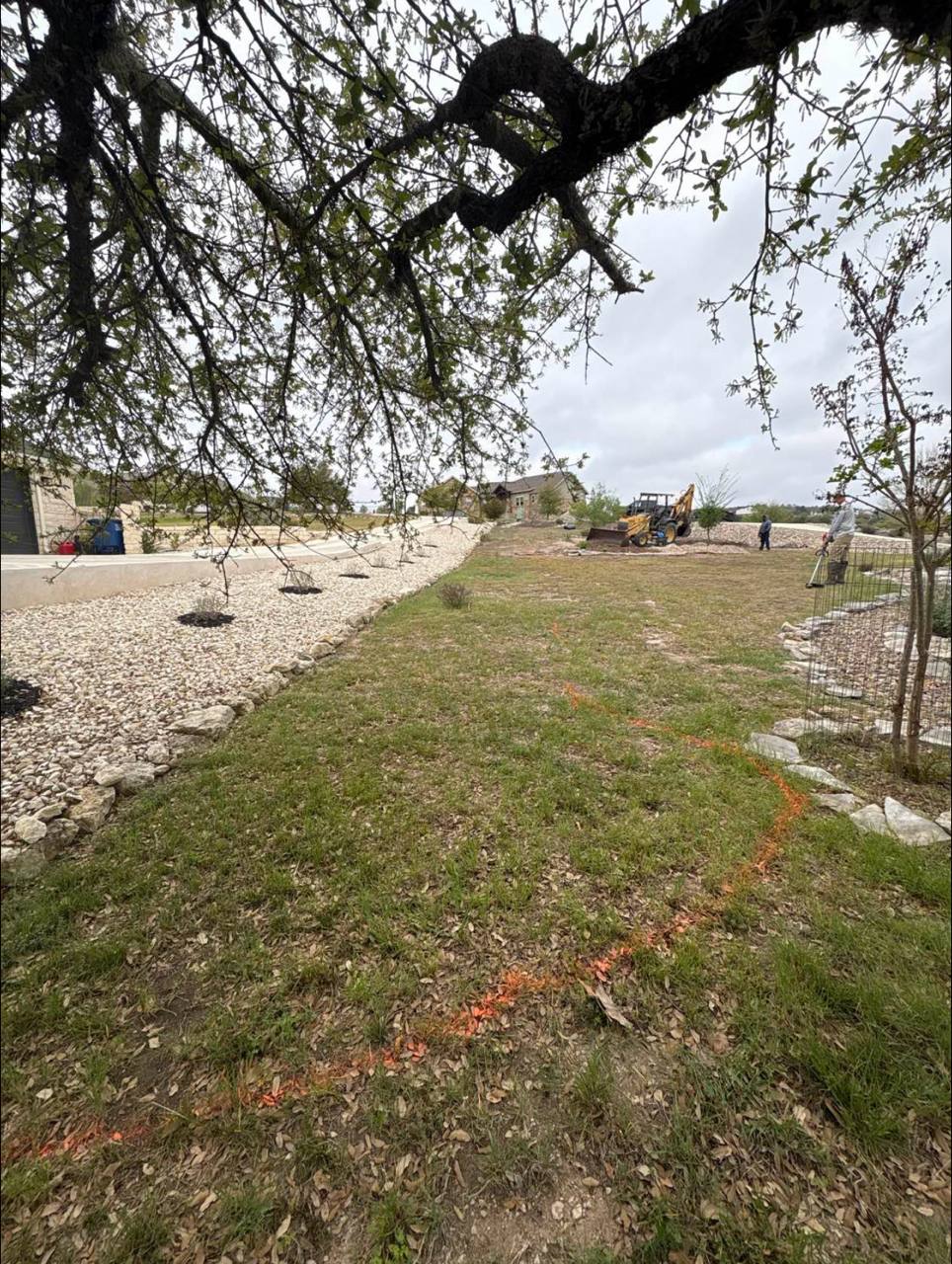 Before — bare lawn, marked for the new beds