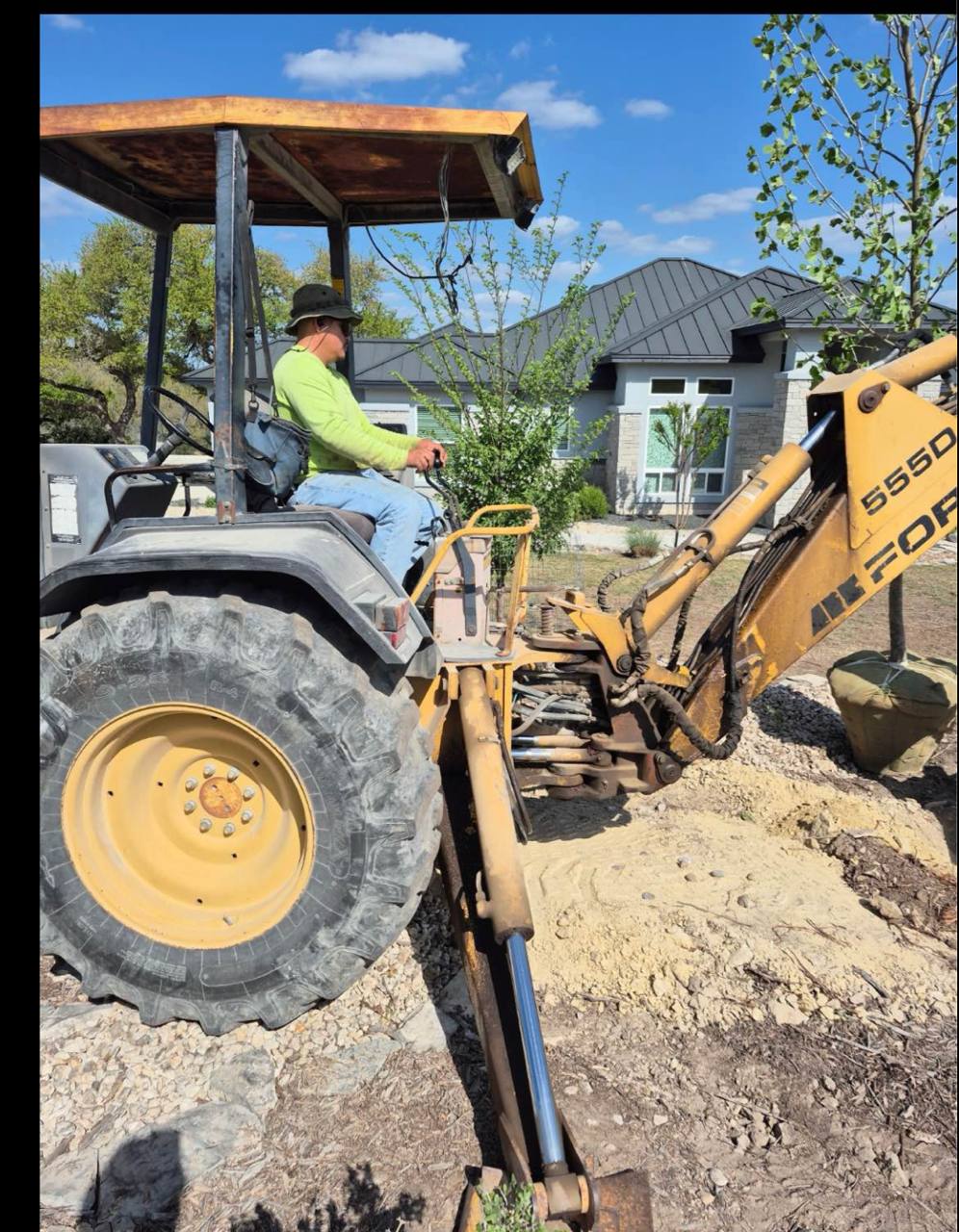 Crew operating the backhoe on a tough job