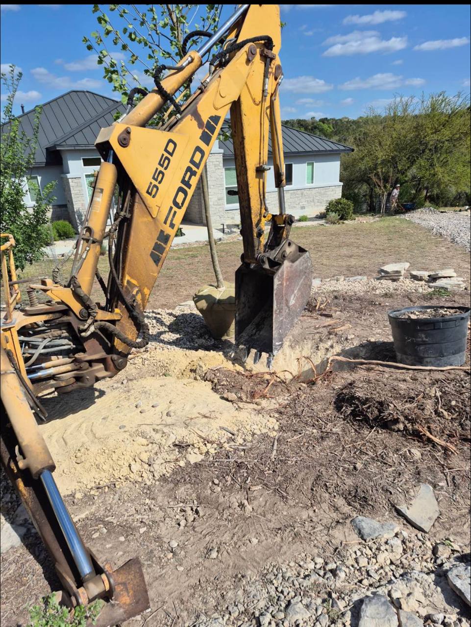 Backhoe through New Braunfels rock for a sycamore